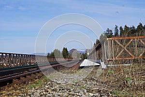 Closeup shot of rusty railway track under a blue sky