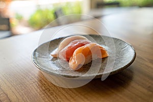 Closeup shot of salmon, tuna, and yellowtail pieces of sushi at a Japanese restaurant