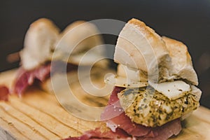 Closeup shot of a sandwich with sliced meat and cheese