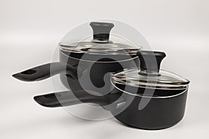 Closeup shot of saucepans on white background