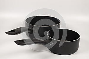 Closeup shot of saucepans on white background