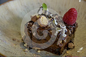 Closeup shot with selective focus of chocolate cake with raspberry