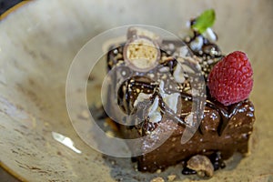 Closeup shot with selective focus of chocolate cake with raspberry