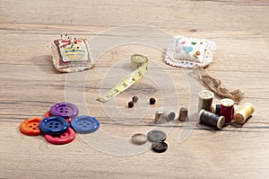 Closeup shot of sewing accessories on the wooden table