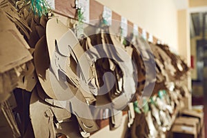 Closeup shot of sewing patterns for shoe details hanging on peg rack at footwear factory