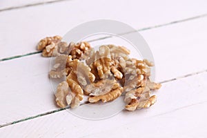 Closeup shot of a shelled walnut pile on a white background