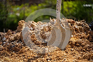 Closeup shot of a shovel stuck in dirt on a construction site