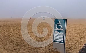 Closeup shot of a sign with access limitation on Jumeirah beach under fog in Dubai UAE