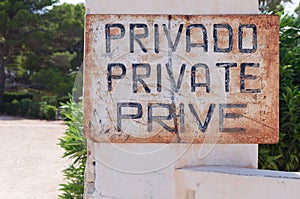 Closeup shot of a sign with text "Privado Private Prive" in the Alicante province, Spain photo