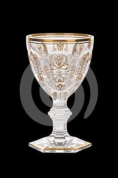 Closeup shot of silver cup with golden ornaments isolated on a black background