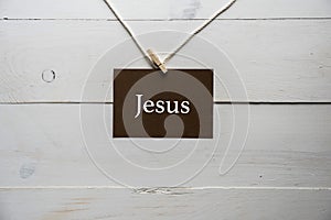 Closeup shot of a sing attached to a string with Jesus written on it