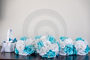 Closeup shot of small bouquets with artificial blue and white flowers with a grey background