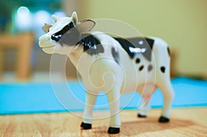 Closeup shot of a small cow toy with a blurred background
