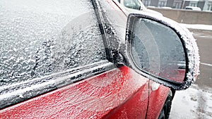 Closeup shot of snow cowered car rear view mirror