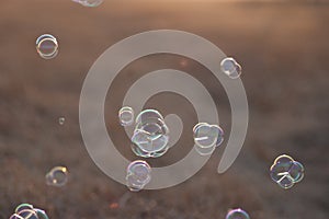 Closeup shot of soap bubbles in the air with a blurred background