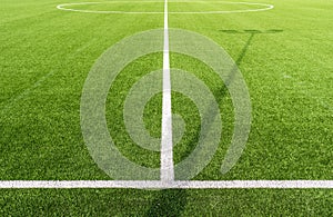 Closeup shot of a soccer pitch with white lines and artificial turf