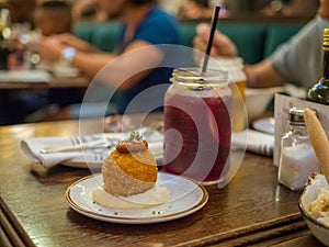 Closeup shot of a Spanish tapa called bomba served at a restaurant in Barcelona, Spain photo