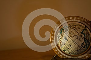 Closeup shot of a spinning globe on a beige background