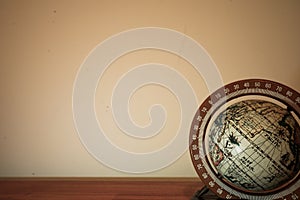 Closeup shot of a spinning globe on a beige background