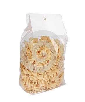 Closeup shot of spiral pasta on a plastic bag isolated on white  background