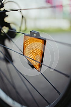 Closeup shot of a spoke reflector on the wheel of a bicycle