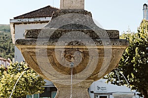 Closeup shot of a stoned fountain near the castle Torre de Moncorvo photo