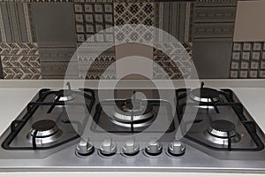 A closeup shot of the stovetop of a modern stove