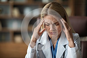 Closeup Shot Of Stressed Doctor Lady Suffering Headache At Workplace