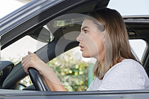 closeup shot stressed young woman driver in car