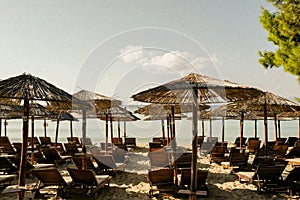 Closeup shot of sun loungers and umbrellas on an empty sandy beach on a sunny day