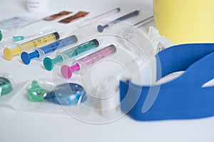 Closeup shot of syringes and a tourniquet