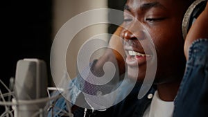Closeup Shot Of Talented Black Male Singer Recording Song At Music Studio