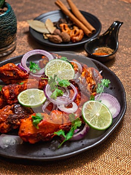 Closeup shot, Tandoori chicken in the black plate
