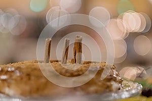 Closeup shot of a tasty caramel cake with cinnamons on