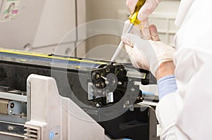 Closeup shot technician fixing photocopier machine