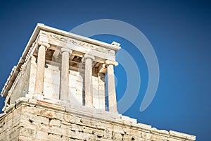 Closeup shot of the temple of Athena Nike with the background of beautiful blue sky