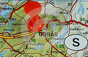 Closeup shot of a thumbtack on the location on a map of Boras city in Sweden