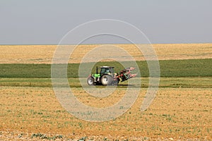 Closeup shot of a tractor working in the field