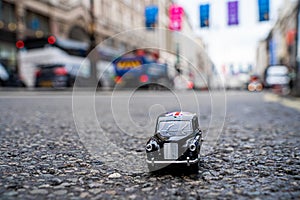 Closeup shot of a traditional black cab driving through the most famous landmarks in London