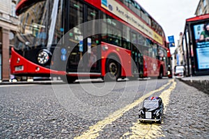 Closeup shot of a traditional black cab driving through the most famous landmarks in London