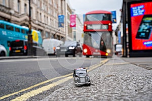 Closeup shot of a traditional black cab driving through the most famous landmarks in London