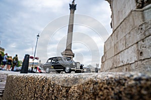 Closeup shot of a traditional black cab driving through the most famous landmarks in London