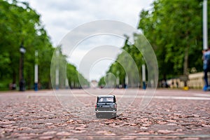 Closeup shot of a traditional black cab driving through the most famous landmarks in London