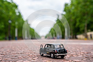 Closeup shot of a traditional black cab driving through the most famous landmarks in London