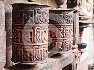 Closeup shot of traditional prayer wheels near a temple in Nepal