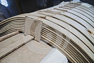 Closeup shot of transformer coil windings with paper insulation