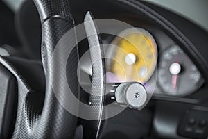 Closeup shot of the turn signal button on the steering wheel of a modern car