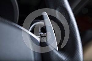 Closeup shot of the turn signal button on the steering wheel of a modern car