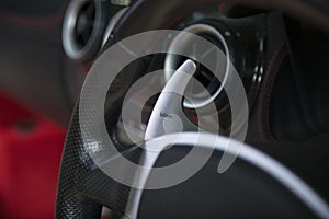 Closeup shot of the turn signal button on the steering wheel of a modern car