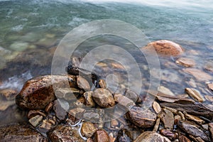 Closeup shot of twet rocks by the bridal veil waterfalls in rondane national park in norway.